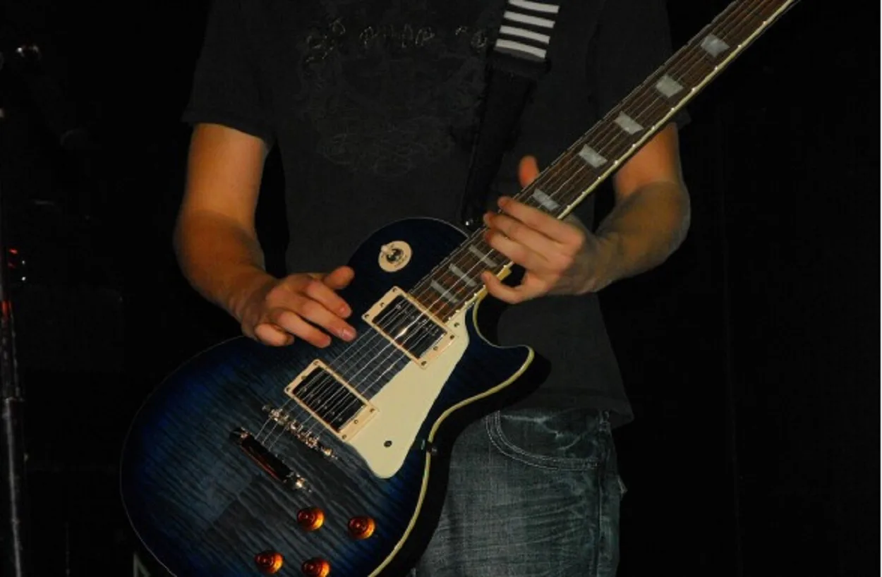 Simpson playing guitar