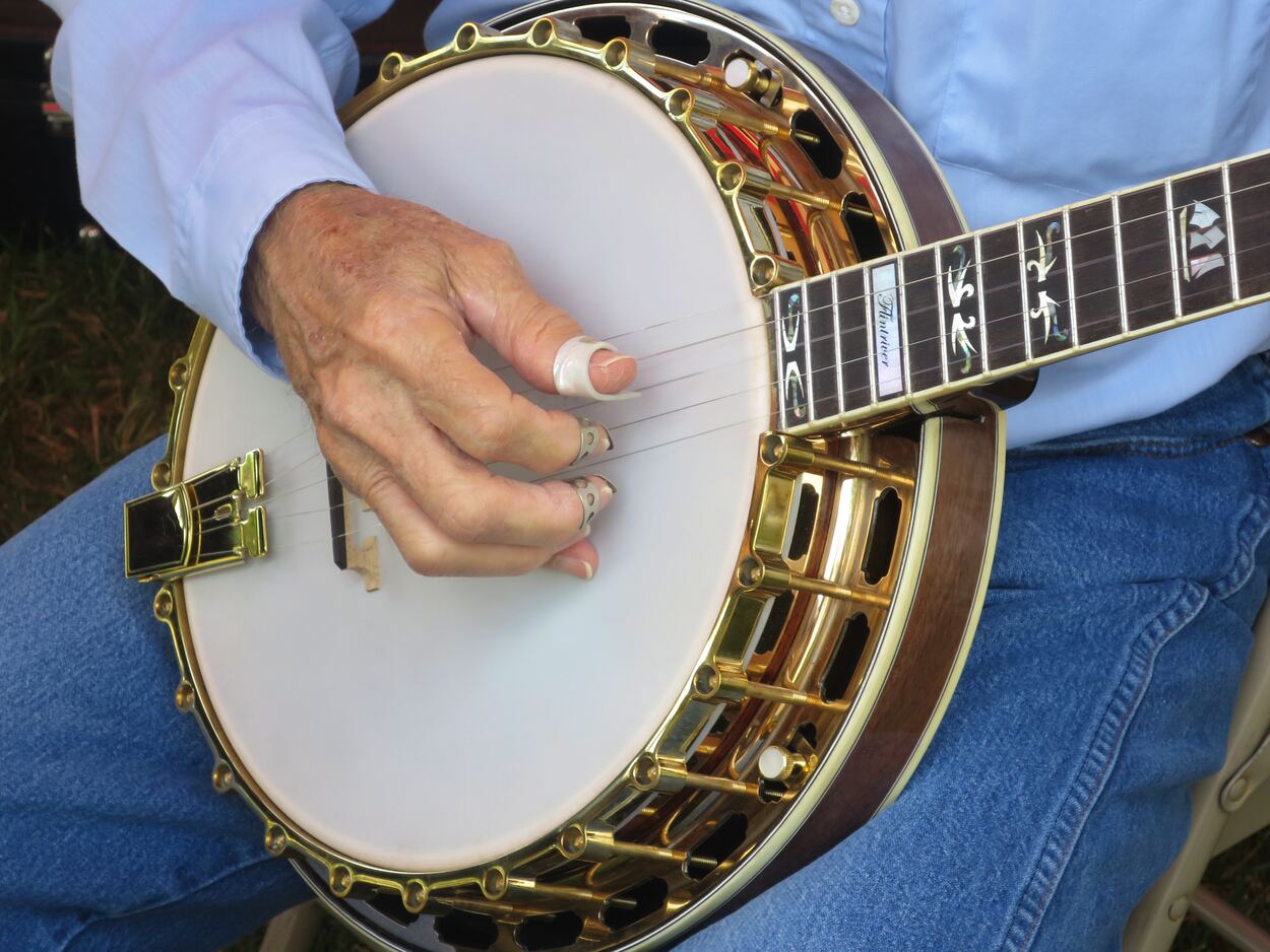 A Person Playing A Banjo