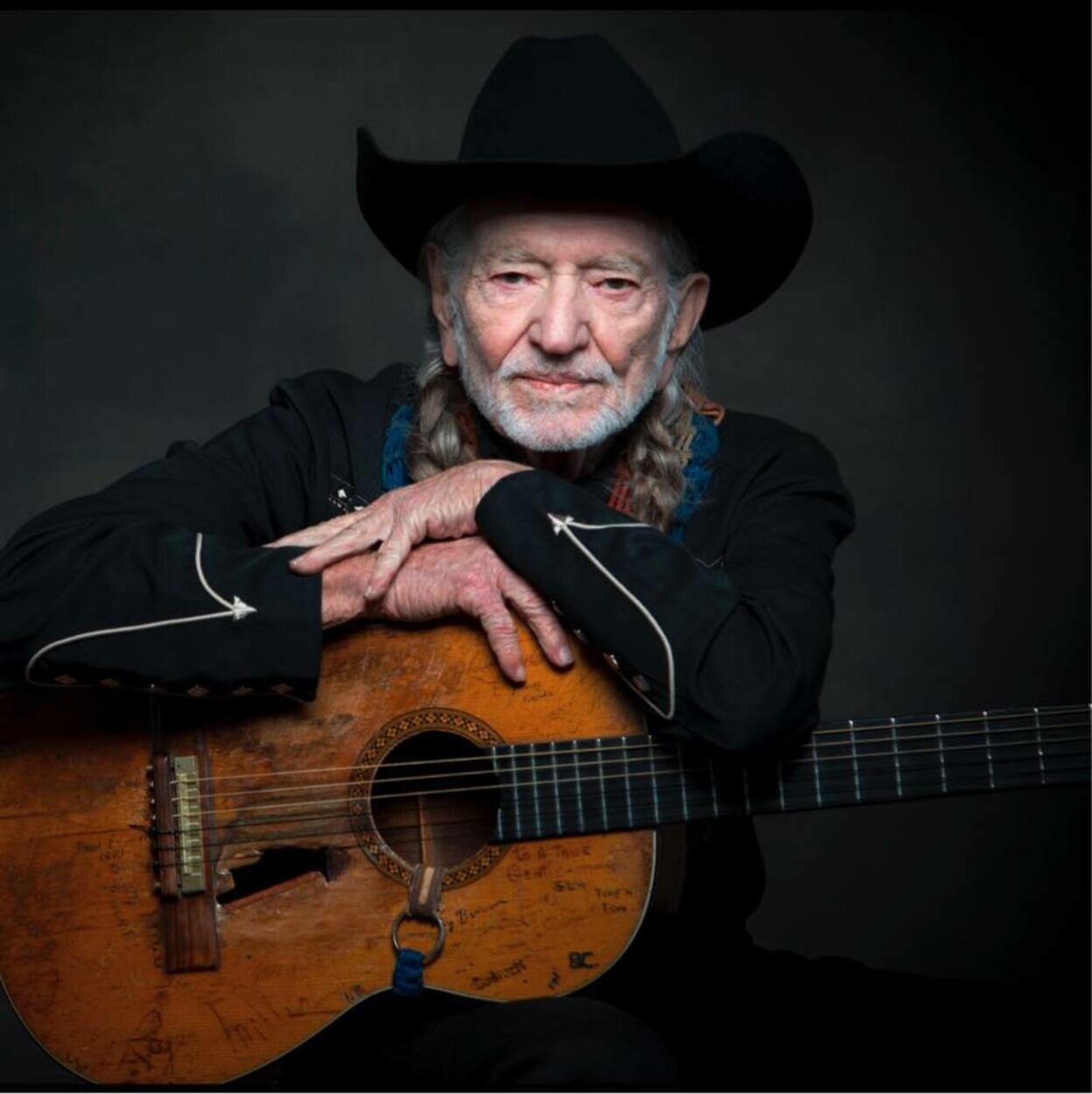 Willie Nelson holding a guitar