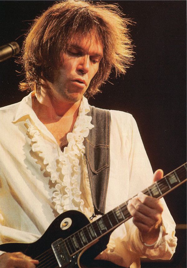 Neil young playing guitar