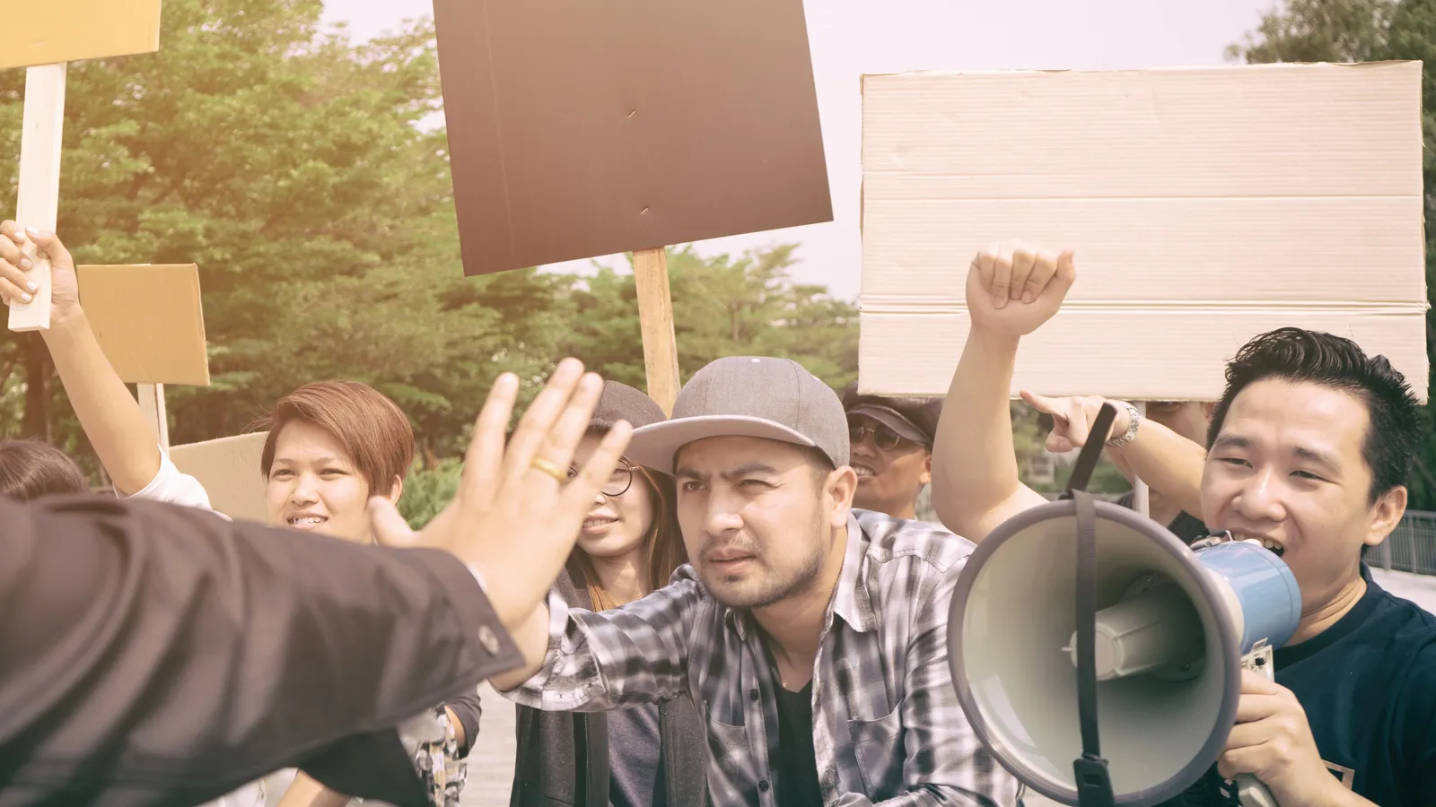 A group of protesters holding protest signs.