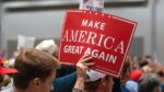 Trump supporter holds up a make AMERICA Great Again sign at presidential candidate Donald Trump’s “Make America Great Again” rally in the convention center.