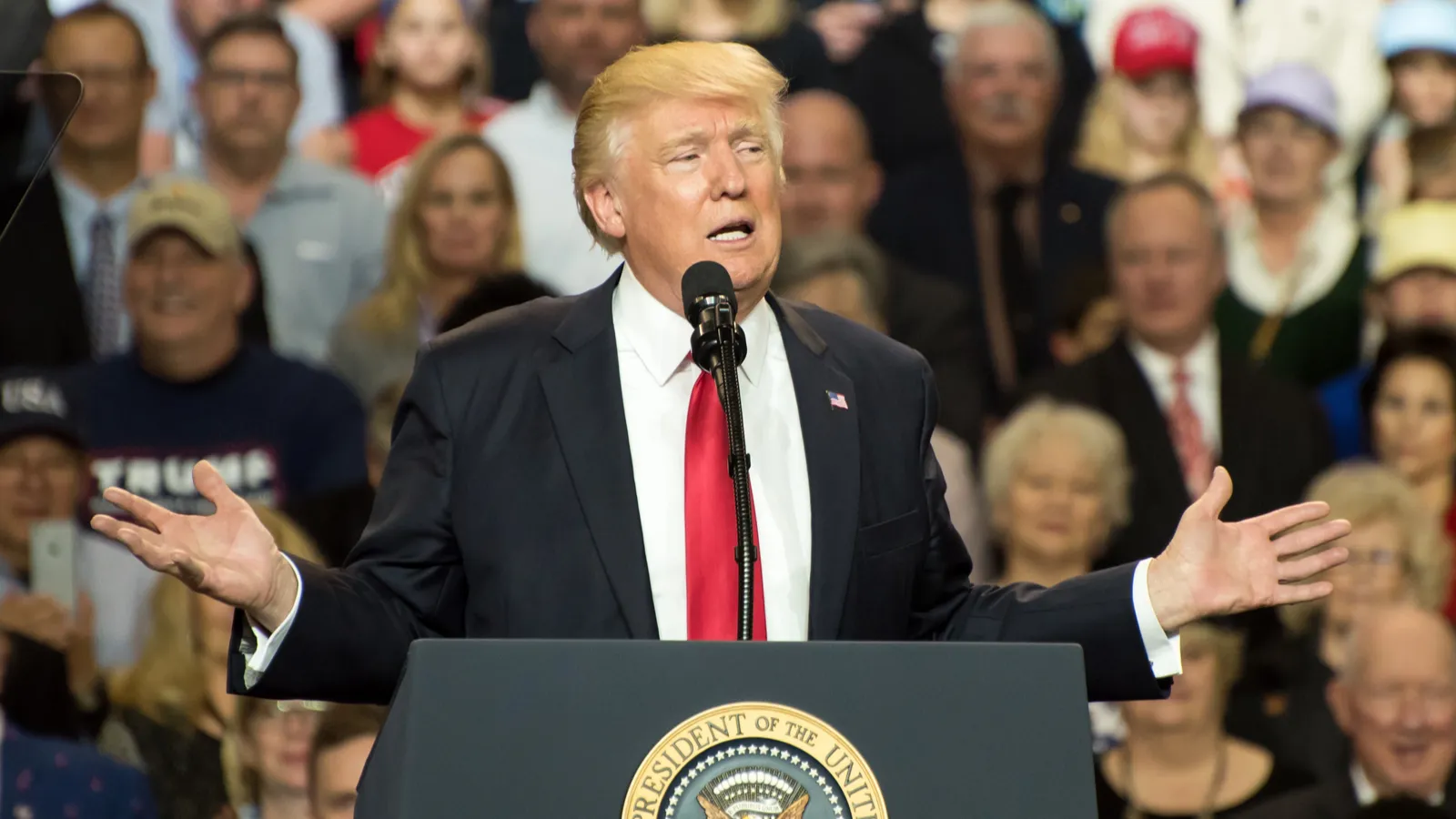President Donald Trump speaking at a podium.