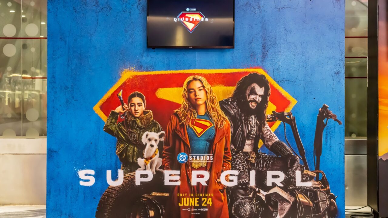 Cinematic promotional poster for a DC Studios superhero film featuring Supergirl displayed at the cinema to promote the movie.